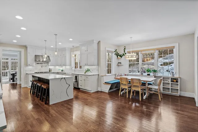 a large open kitchen with a table and chairs in it