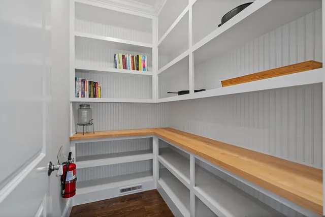 a view of storage and utility room with racks on the wall