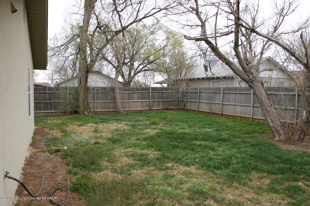 203 Southwest 41st Avenue Amarillo, TX 79110 - Photo 23 of 25 a view of a backyard with a large tree