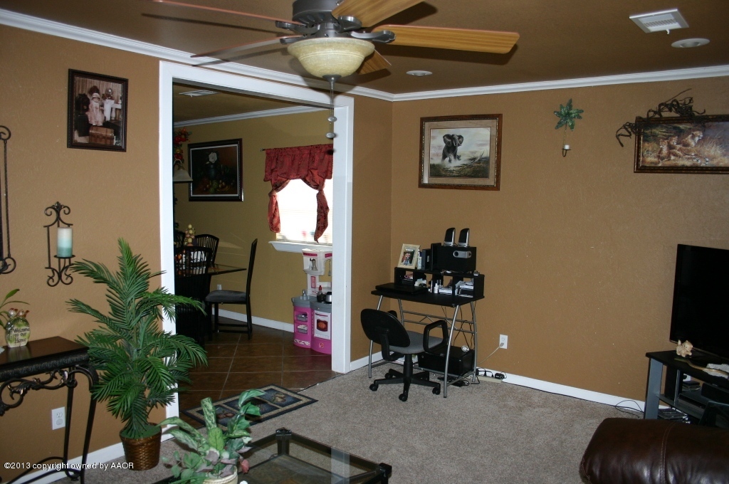 203 Southwest 41st Avenue Amarillo, TX 79110 - Photo 4 of 25 a workspace with furniture and a potted plant
