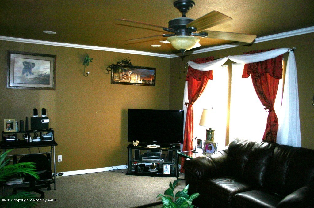 203 Southwest 41st Avenue Amarillo, TX 79110 - Photo 5 of 25 a living room with furniture and a flat screen tv
