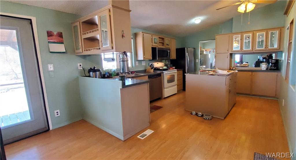 407 South Houck Road Golden Valley, AZ 86413 - Photo 41 of 65 a kitchen with cabinets and wooden floor