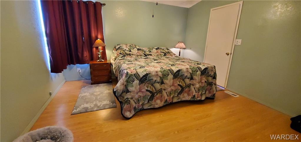 407 South Houck Road Golden Valley, AZ 86413 - Photo 52 of 65 a bed sitting in a bedroom next to a window