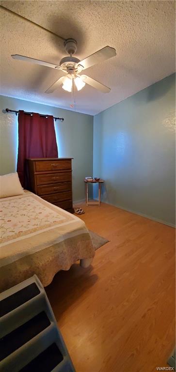 407 South Houck Road Golden Valley, AZ 86413 - Photo 64 of 65 a bedroom with a bed and a ceiling fan