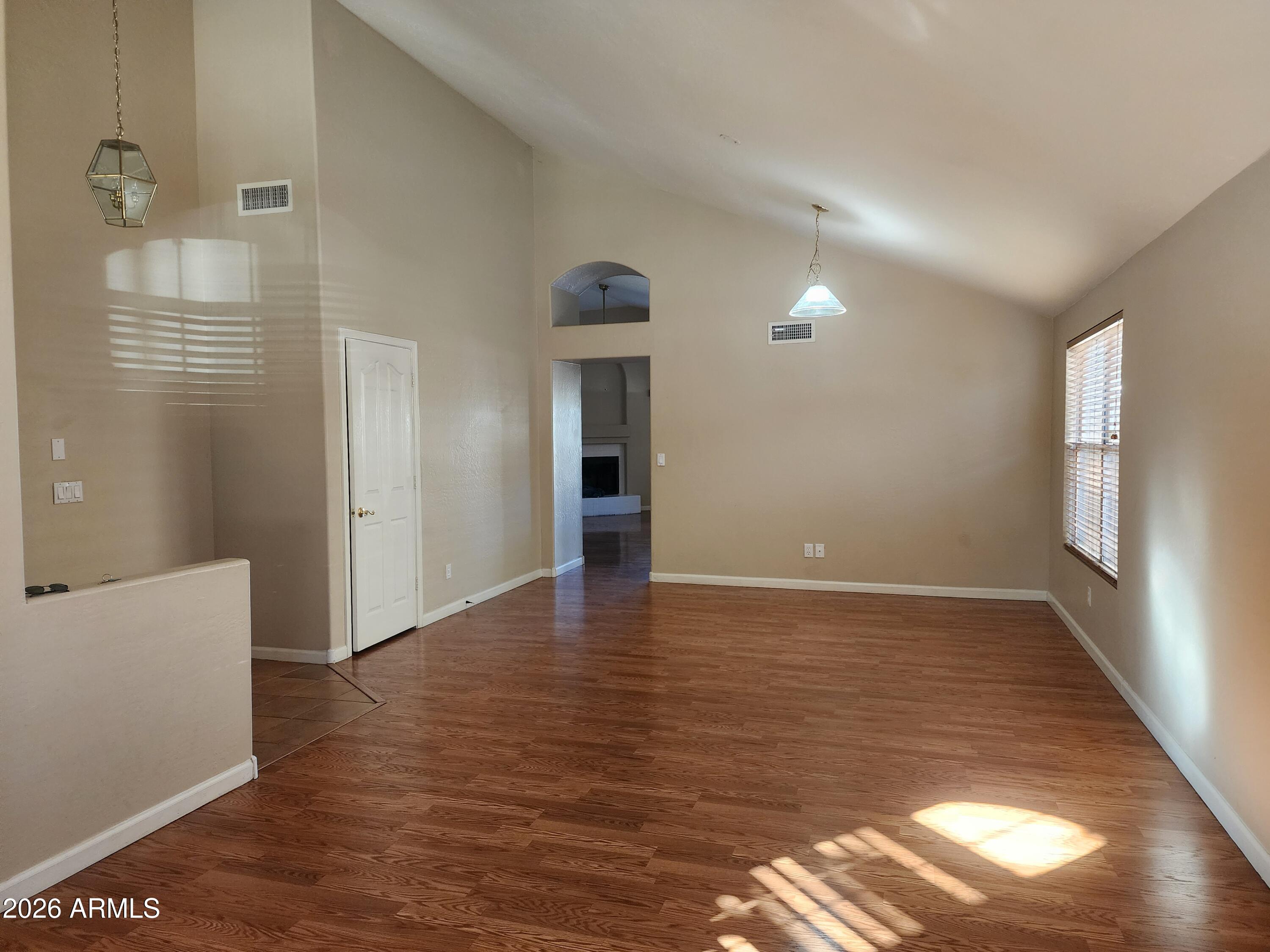 4790 West Tulsa Street Chandler, AZ 85226 - Photo 13 of 30 a view of an empty room with wooden floor and a window