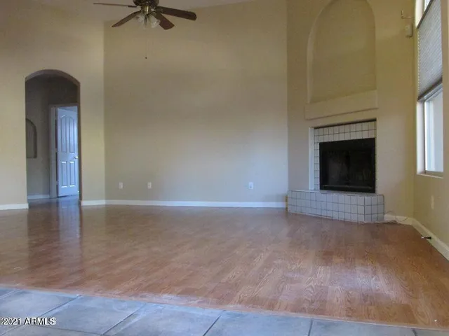 a view of an empty room with a fireplace and a window