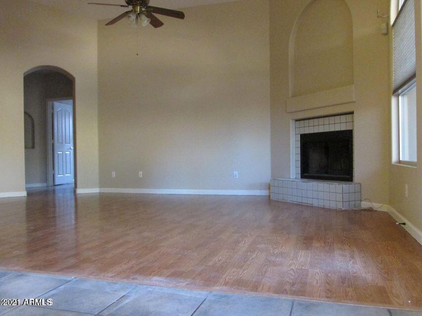 4790 West Tulsa Street Chandler, AZ 85226 - Photo 14 of 30 a view of an empty room with a fireplace and a window