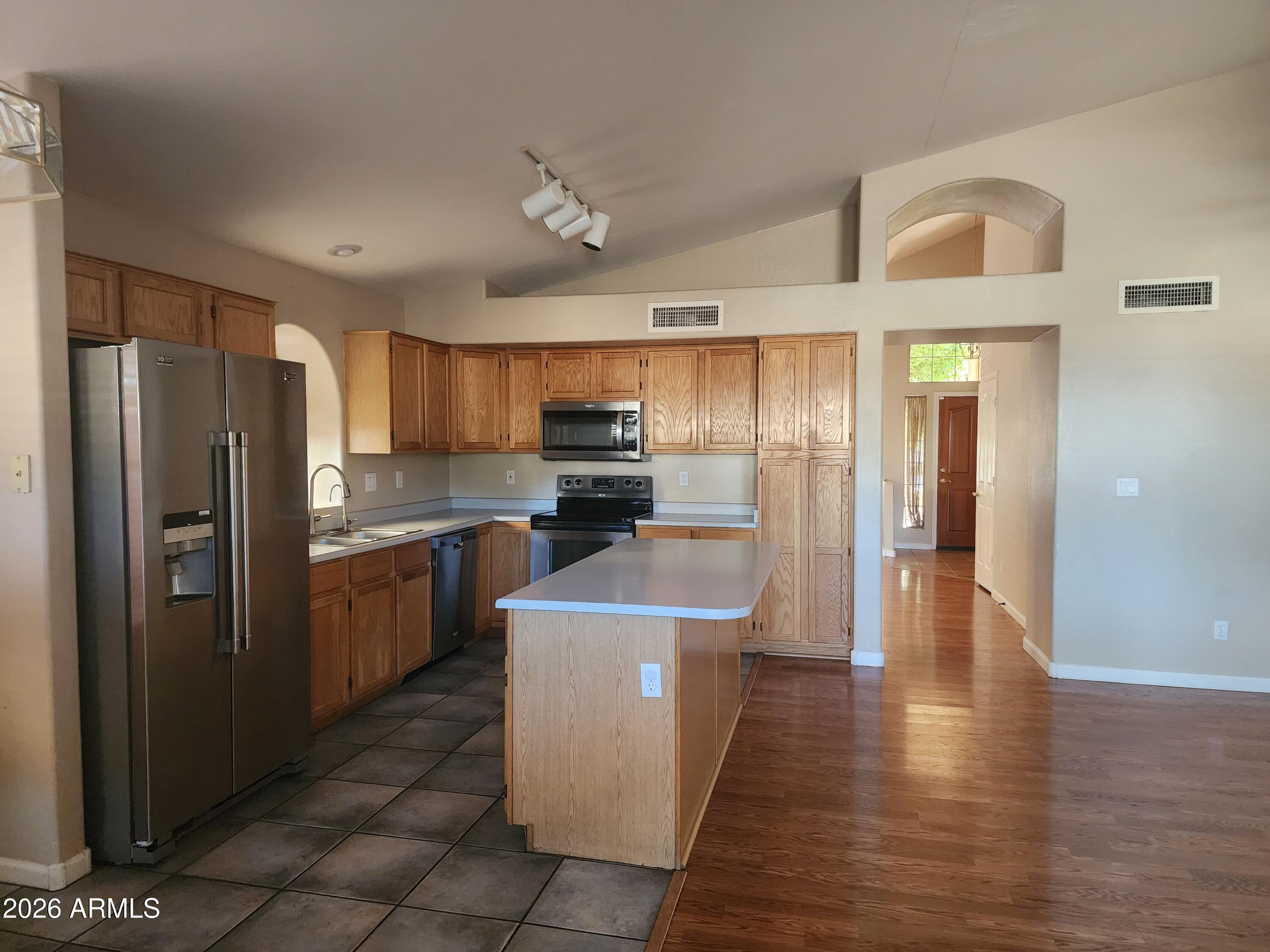 4790 West Tulsa Street Chandler, AZ 85226 - Photo 17 of 30 a kitchen with stainless steel appliances granite countertop a refrigerator a stove top oven a sink and dishwasher
