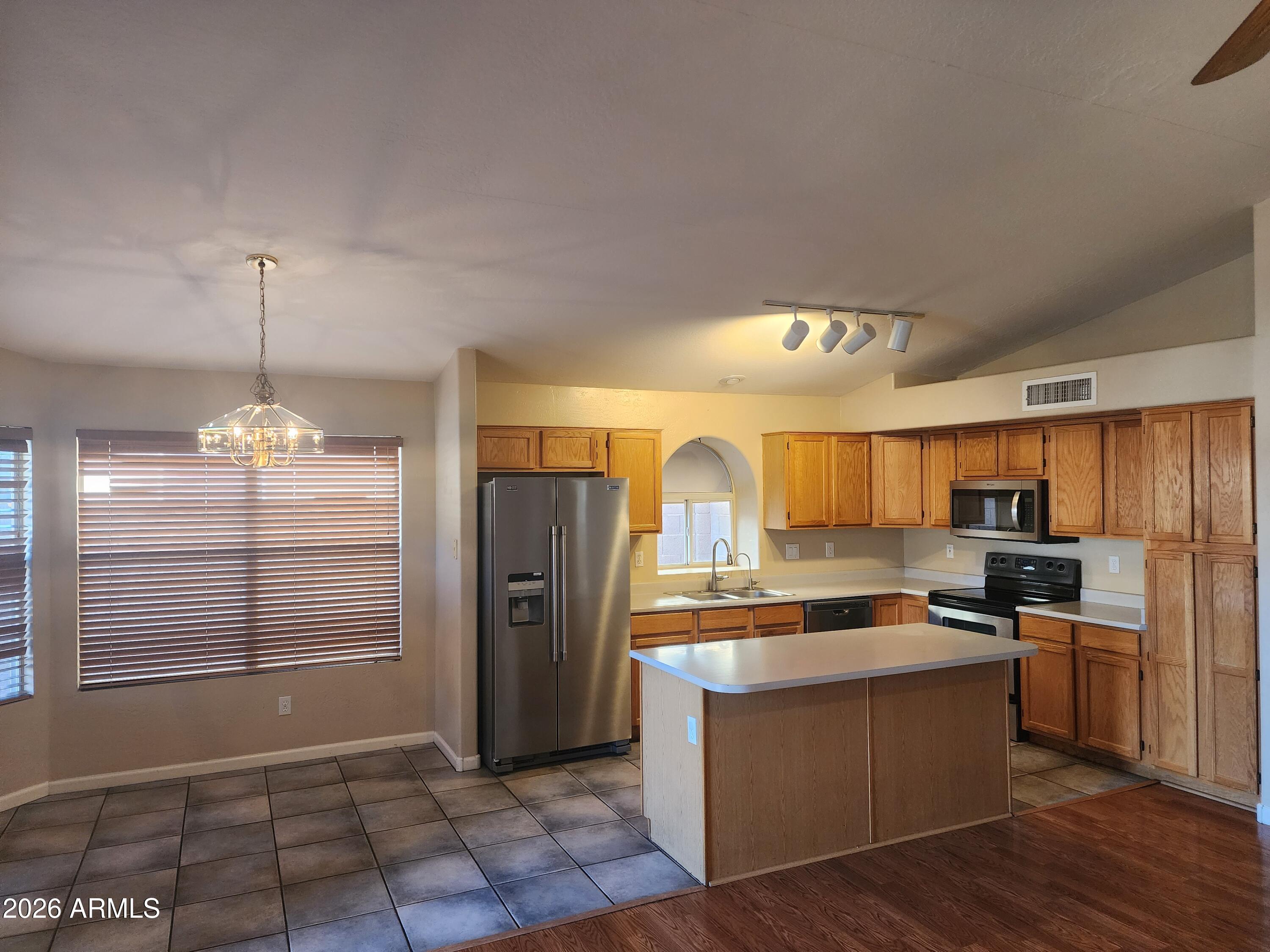 4790 West Tulsa Street Chandler, AZ 85226 - Photo 20 of 30 a kitchen with stainless steel appliances granite countertop a refrigerator a stove a sink and a oven