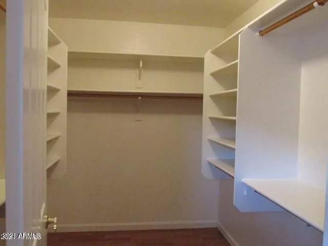 a view of walk in closet with empty racks