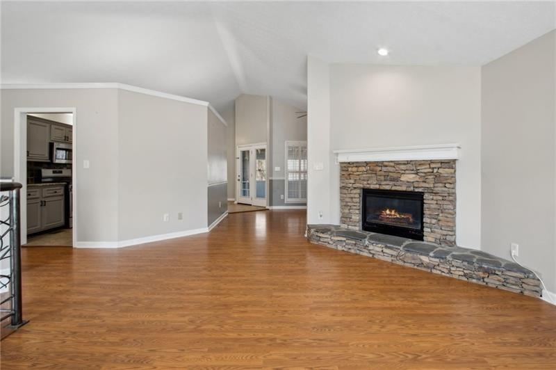 6604 Windbrook Way Flowery Branch, GA 30542 - Photo 11 of 64 a view of empty room with wooden floor and fireplace