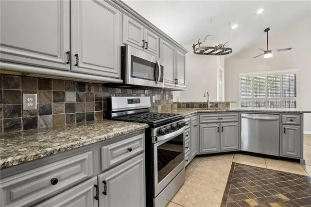 a kitchen with granite countertop a sink and a window
