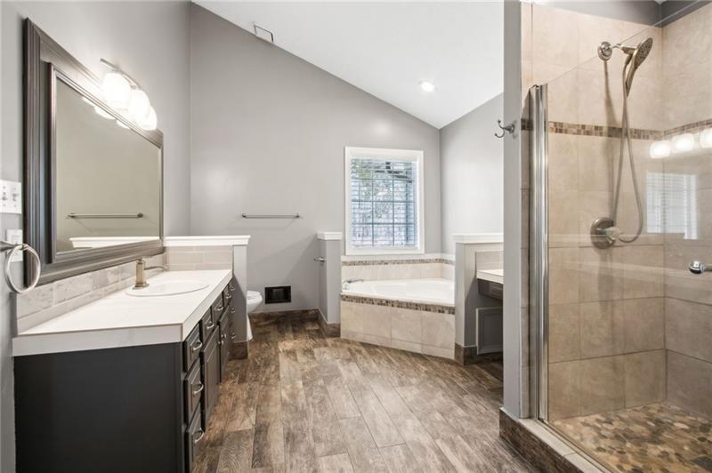6604 Windbrook Way Flowery Branch, GA 30542 - Photo 32 of 64 a bathroom with a double vanity sink mirror and shower