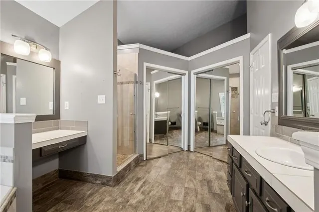 a bathroom with a granite countertop toilet a sink and a mirror