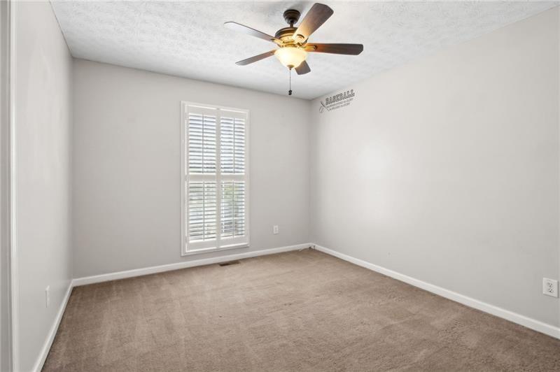 6604 Windbrook Way Flowery Branch, GA 30542 - Photo 35 of 64 an empty room with windows and fan