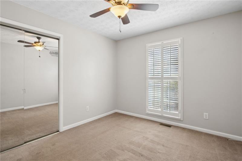 6604 Windbrook Way Flowery Branch, GA 30542 - Photo 36 of 64 an empty room with windows and fan