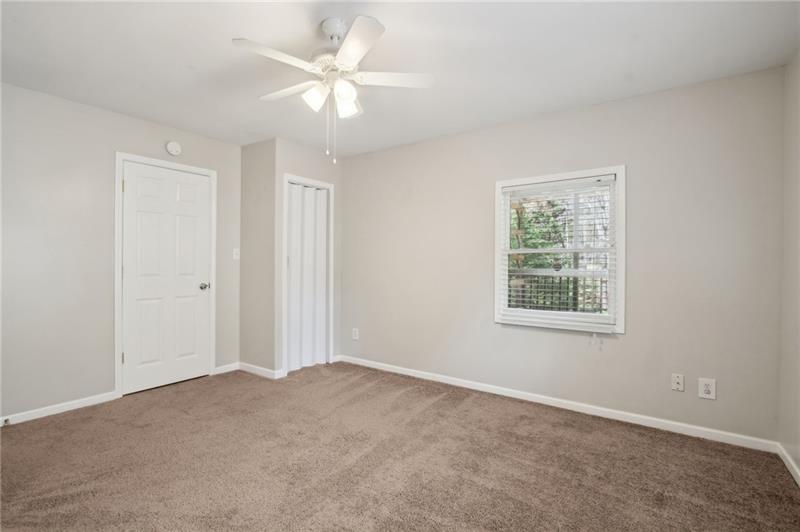 6604 Windbrook Way Flowery Branch, GA 30542 - Photo 48 of 64 an empty room with windows and fan
