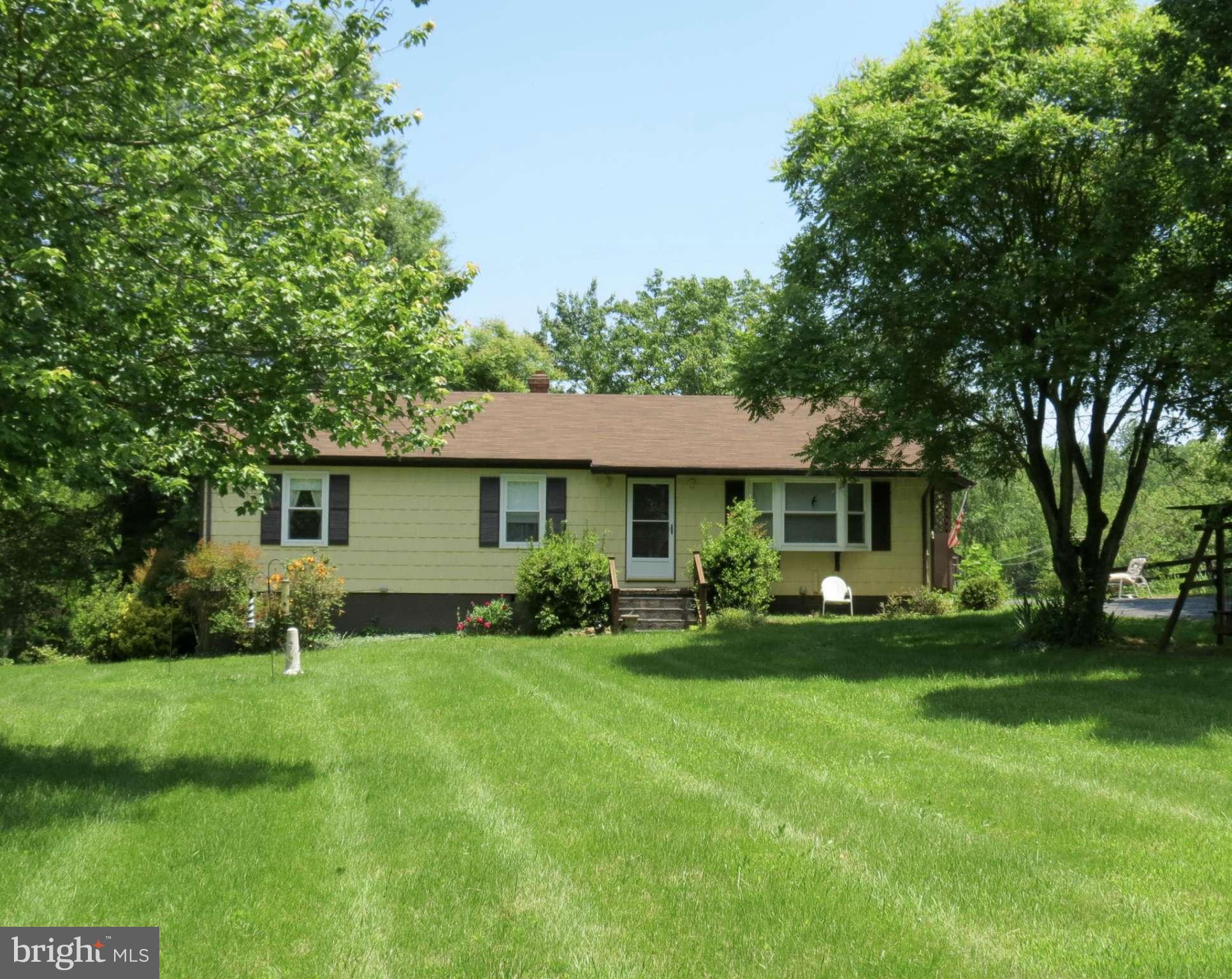 9527 Eggbornsville Road Rixeyville, VA 22737 - Photo 1 of 11 a front view of a house with a garden and trees