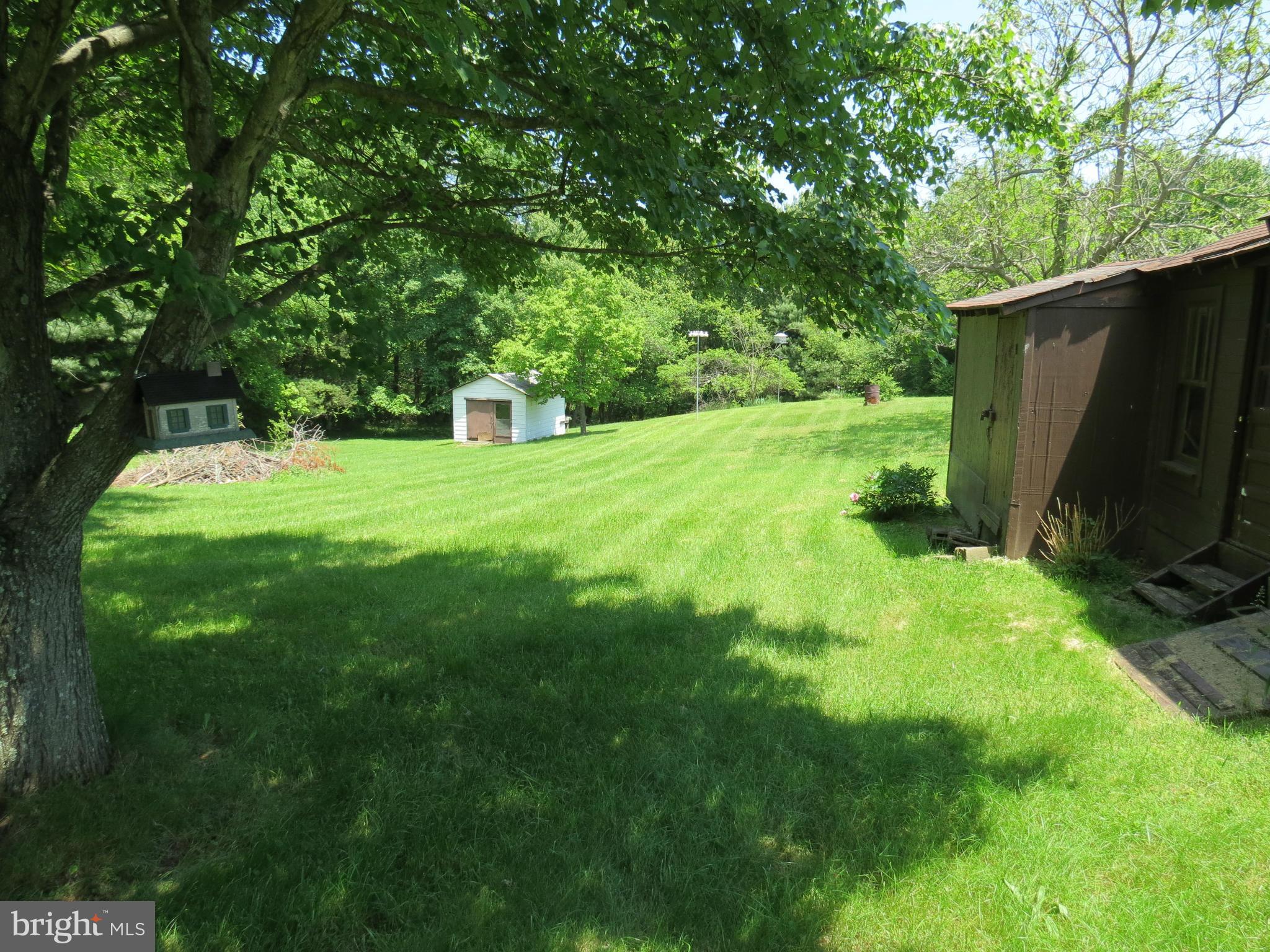 9527 Eggbornsville Road Rixeyville, VA 22737 - Photo 4 of 11 a backyard of a house with barbeque oven table and chairs