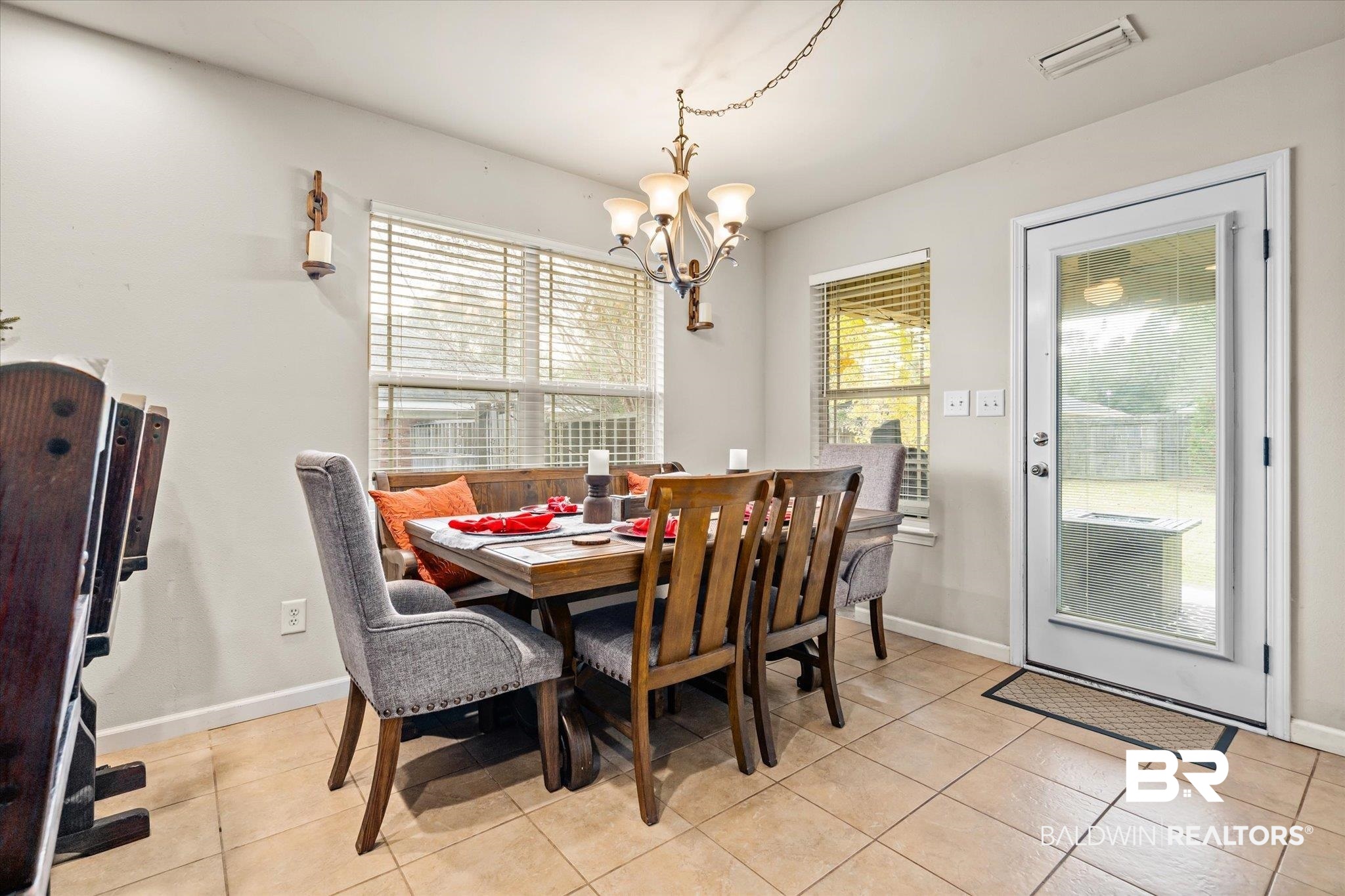 2855 Rebecca Drive West Mobile, AL 36618 - Photo 8 of 22 Tiled dining space with plenty of natural light and an inviting chandelier