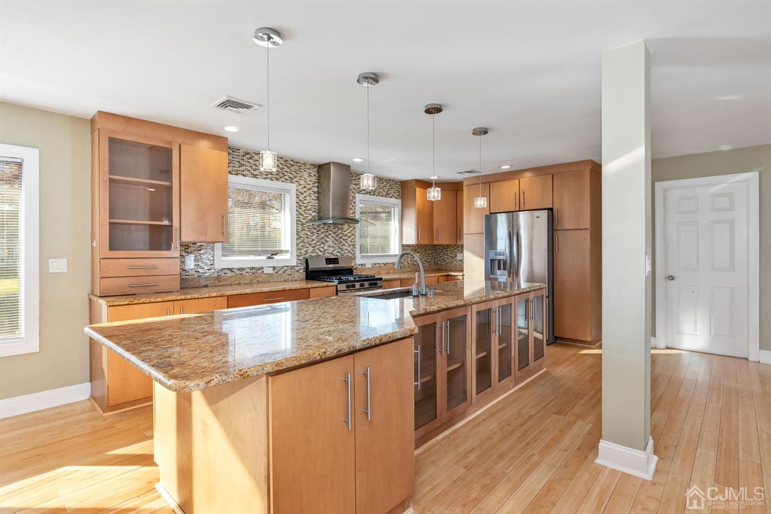 46 Harvard Road Old Bridge, NJ 08859 - Photo 5 of 43 a kitchen with stainless steel appliances granite countertop a sink a stove and a wooden floors