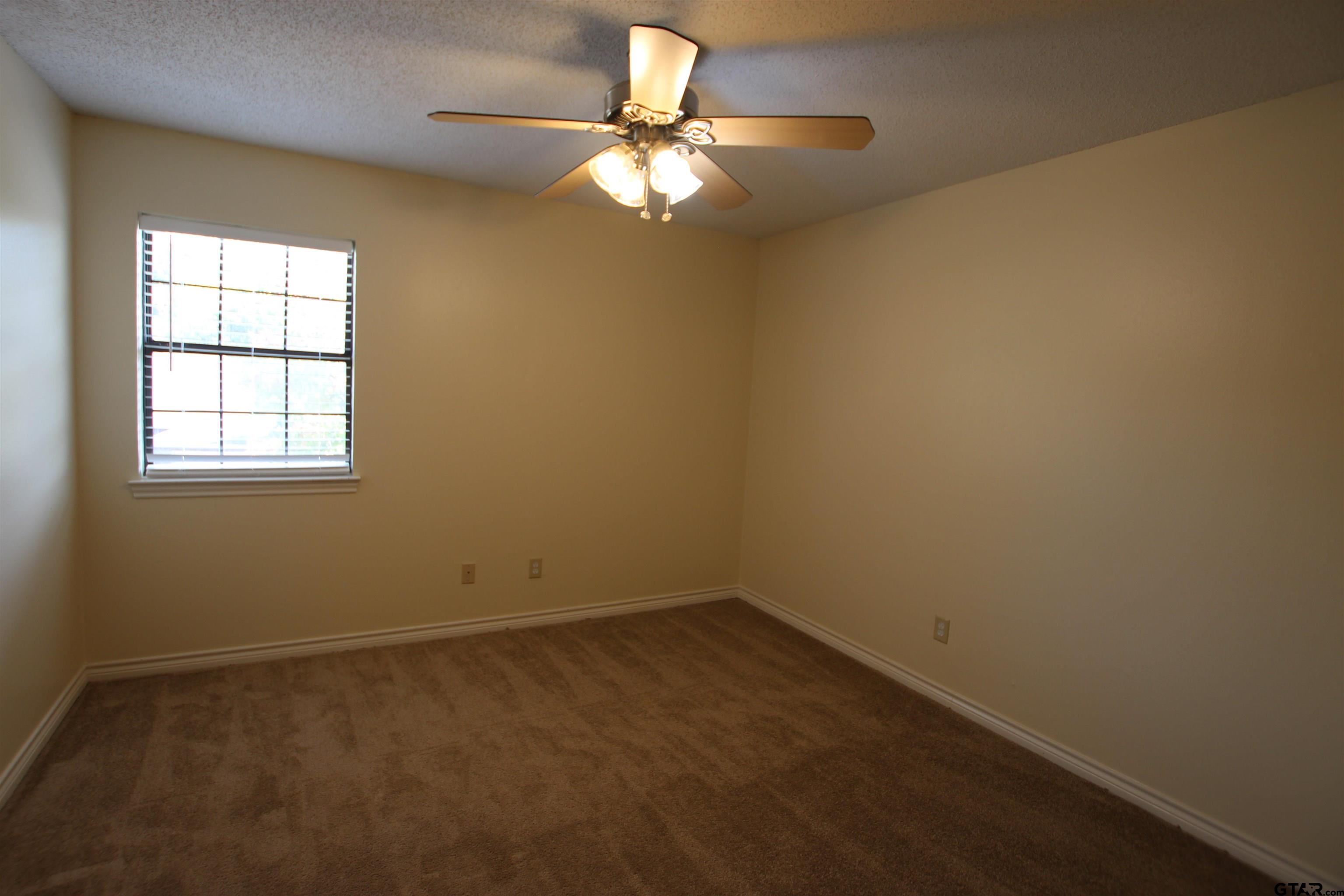 5875 Creekside Circle Tyler, TX 75703 - Photo 26 of 32 an empty room with a window and a fan