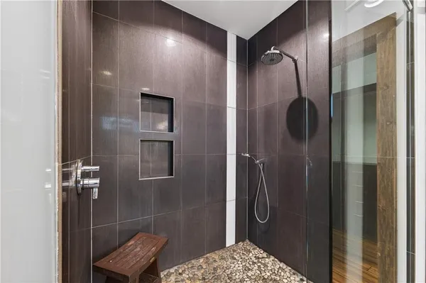 a bathroom with a toilet and a shower