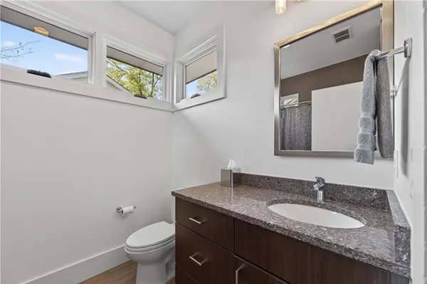 a bathroom with a granite countertop sink mirror and vanity