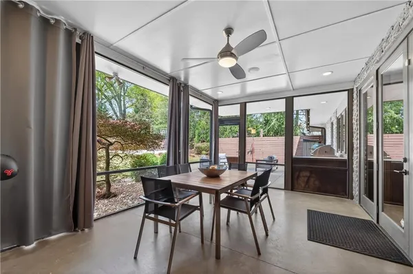 a outdoor space with patio the couches and a fireplace with the potted plants