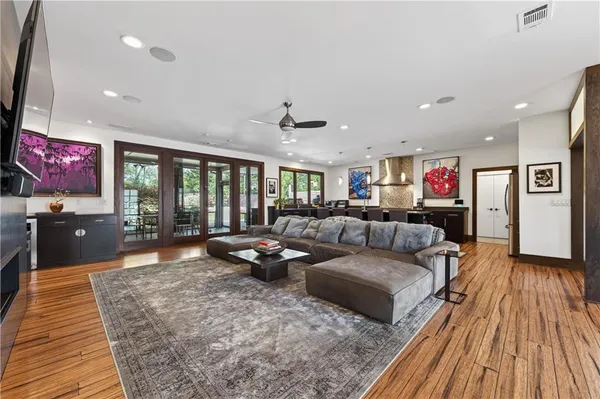 a living room with furniture and wooden floor