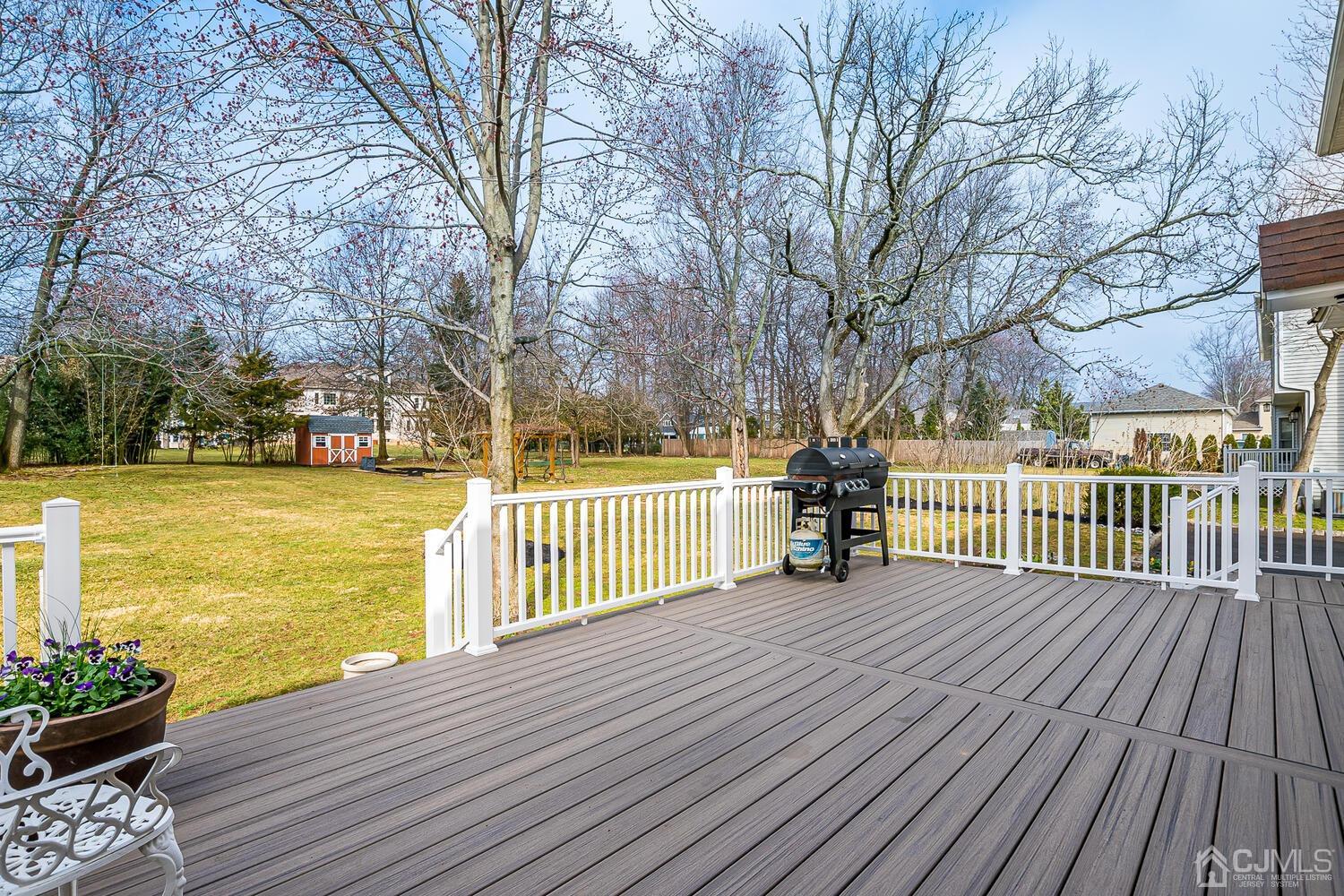 9 Ramsey Road Edison, NJ 08820 - Photo 31 of 37 a view of a deck with wooden floor and fence with a large garden
