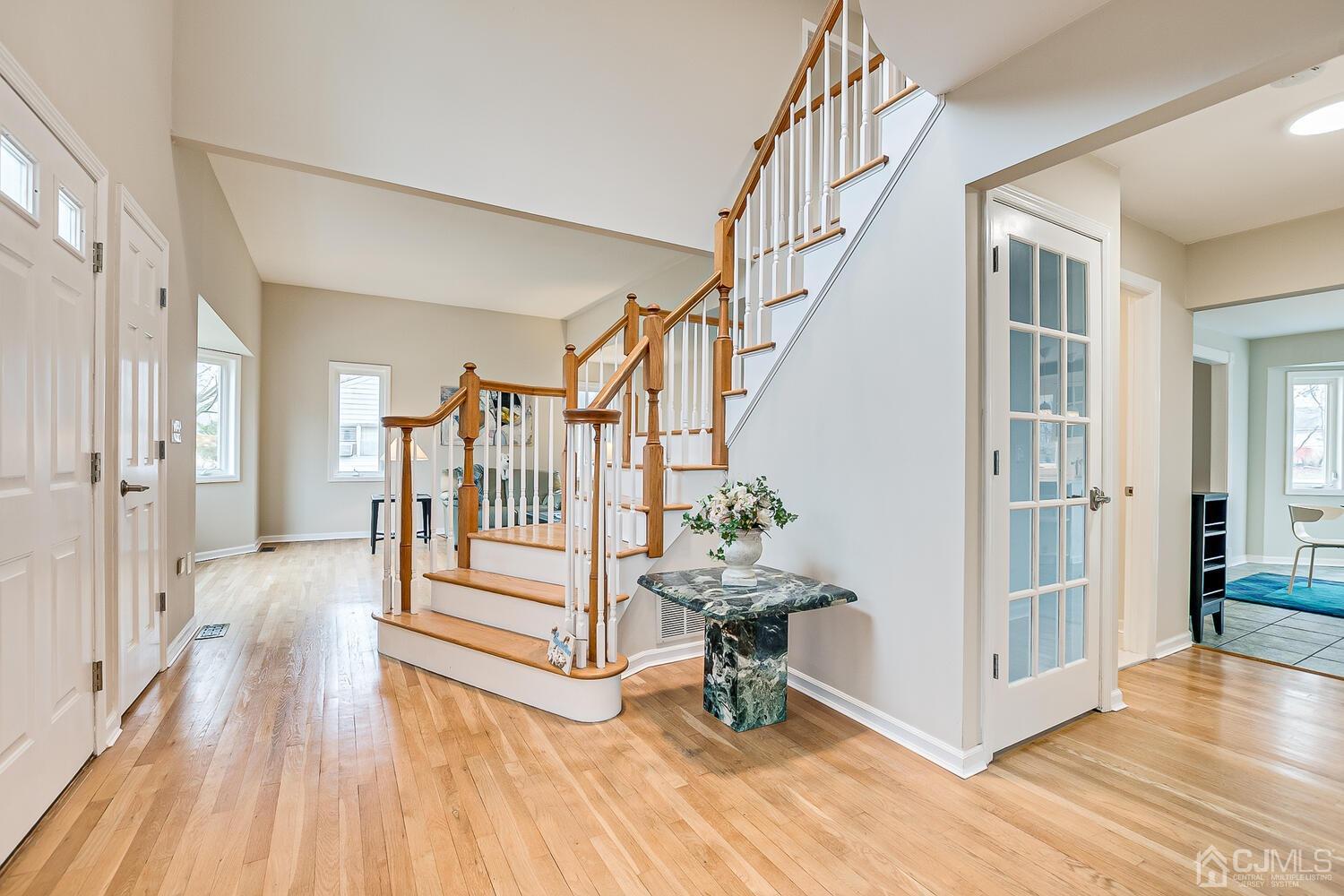 9 Ramsey Road Edison, NJ 08820 - Photo 8 of 37 a view of entryway with wooden floor and stairs