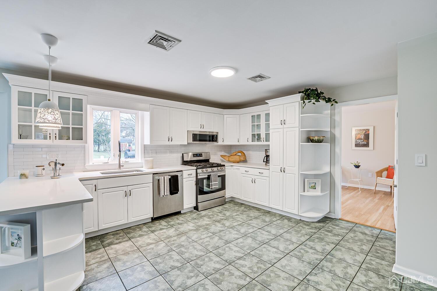 9 Ramsey Road Edison, NJ 08820 - Photo 10 of 37 a kitchen with a sink refrigerator and cabinets