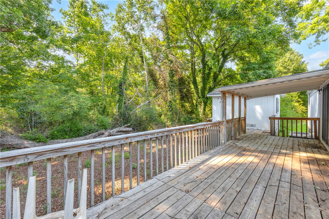 150 Newberry Road Walhalla, SC 29691 - Photo 26 of 47 A spacious wooden deck extends into a lush, tree-filled landscape.