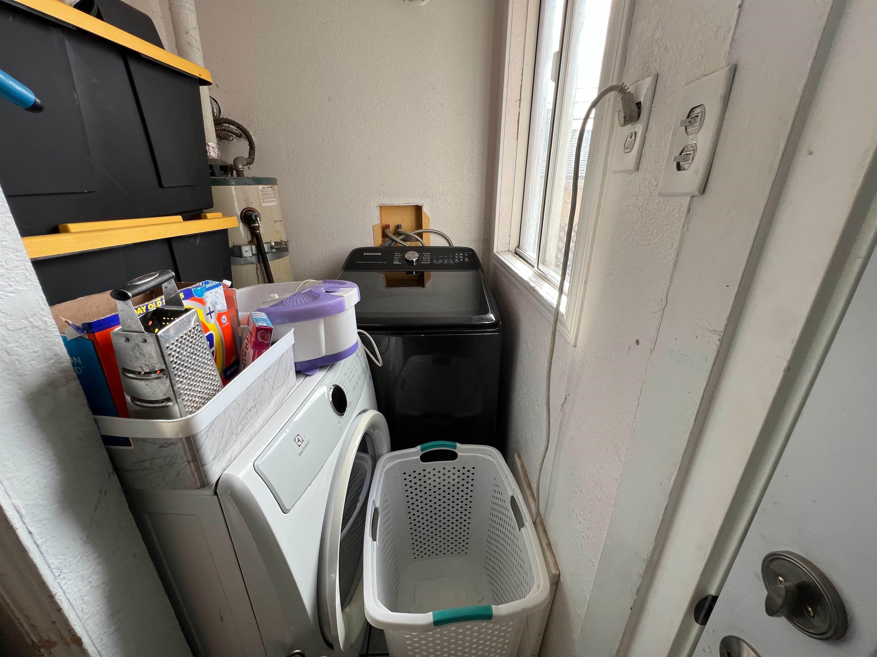 1803 Rosedale Avenue Oakland, CA 94601 - Photo 13 of 28 Washroom featuring washer / dryer, a textured wall, and water heater