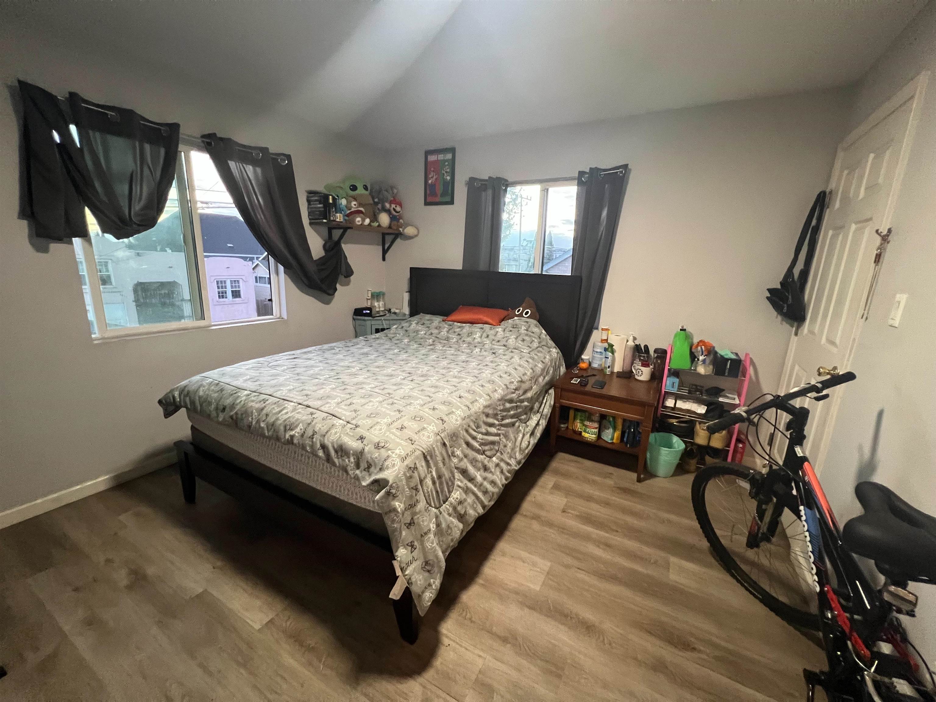 1803 Rosedale Avenue Oakland, CA 94601 - Photo 19 of 28 Bedroom with vaulted ceiling and wood finished floors