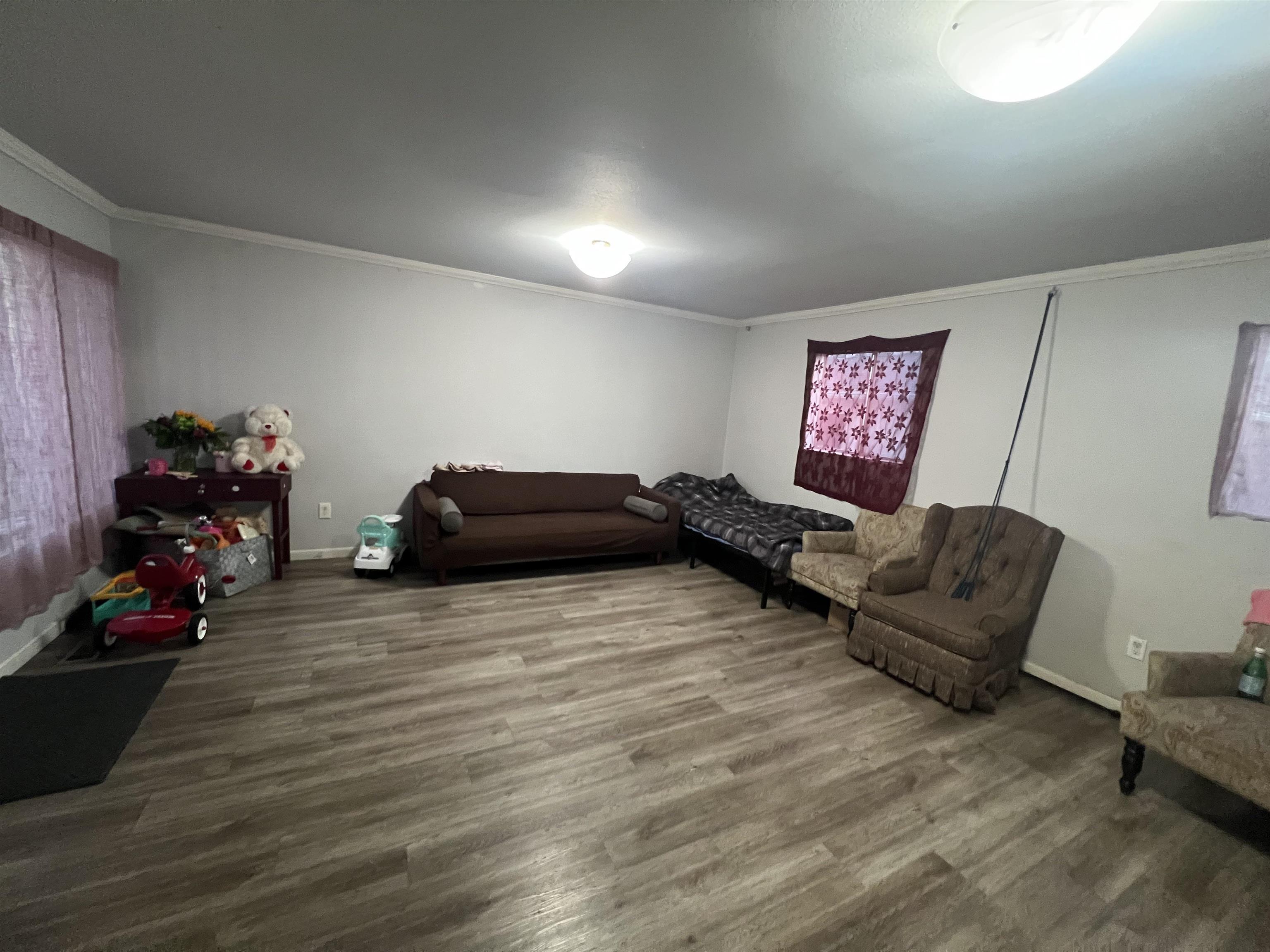 1803 Rosedale Avenue Oakland, CA 94601 - Photo 21 of 28 Living area with crown molding and wood finished floors