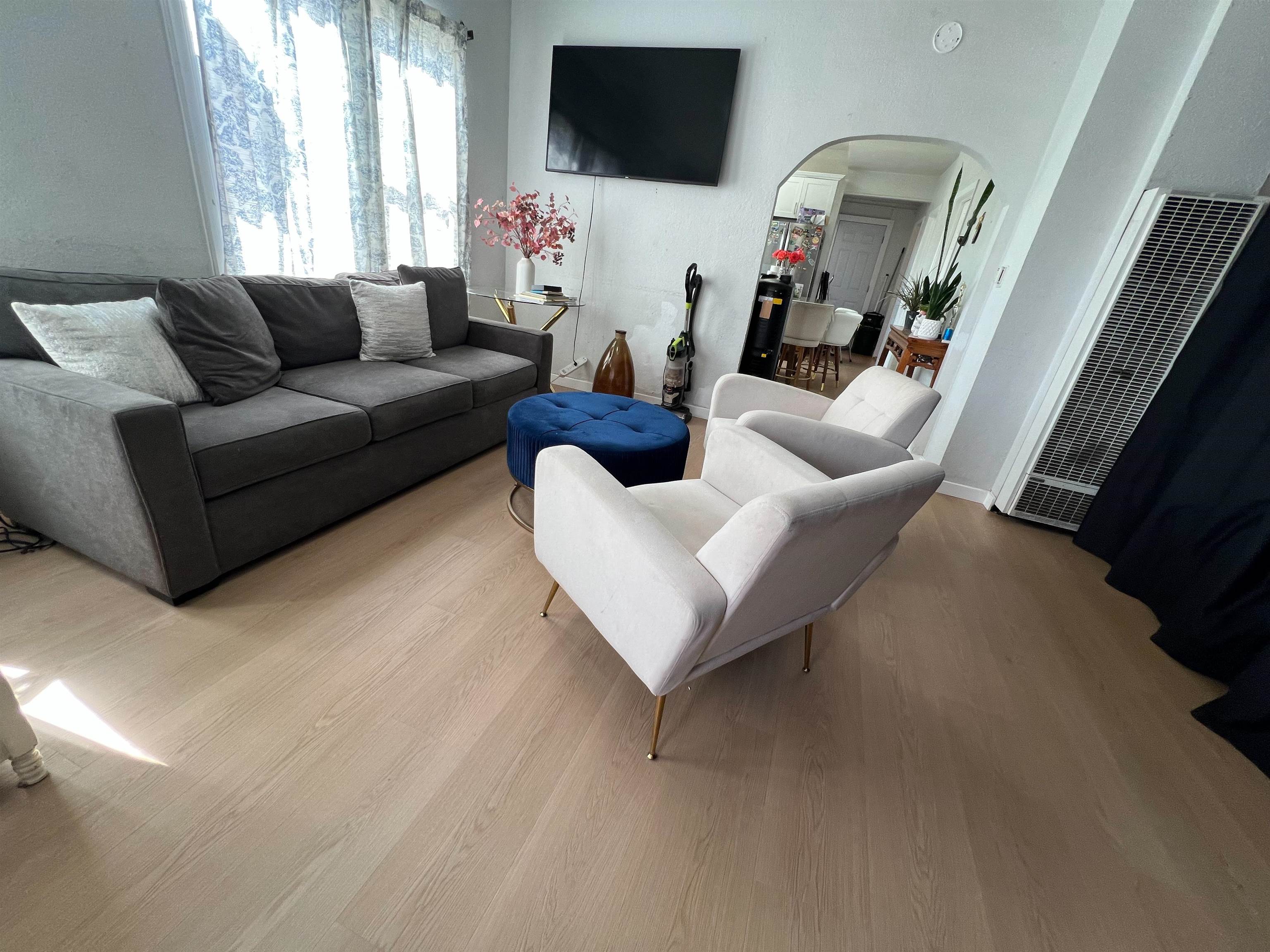 1803 Rosedale Avenue Oakland, CA 94601 - Photo 9 of 28 Living area featuring arched walkways, wood finished floors, and a heating unit