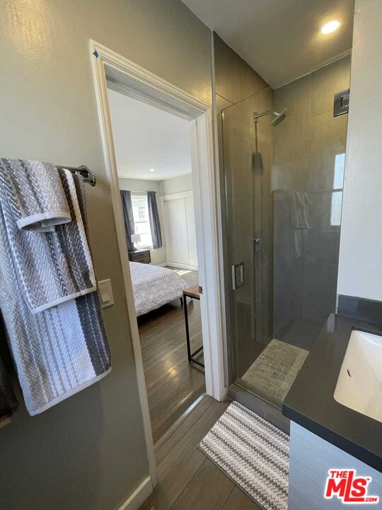 348 South Elm Drive, Unit 6 Beverly Hills, CA 90212 - Photo 15 of 17 a bedroom with a bed and a mirror