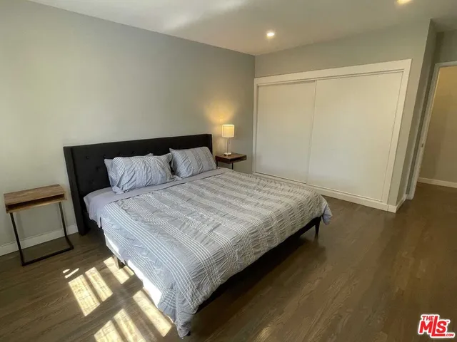 a bedroom with a bed and a night stand