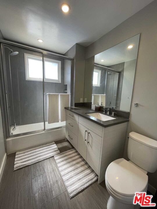 348 South Elm Drive, Unit 6 Beverly Hills, CA 90212 - Photo 10 of 17 a bathroom with a toilet sink and mirror