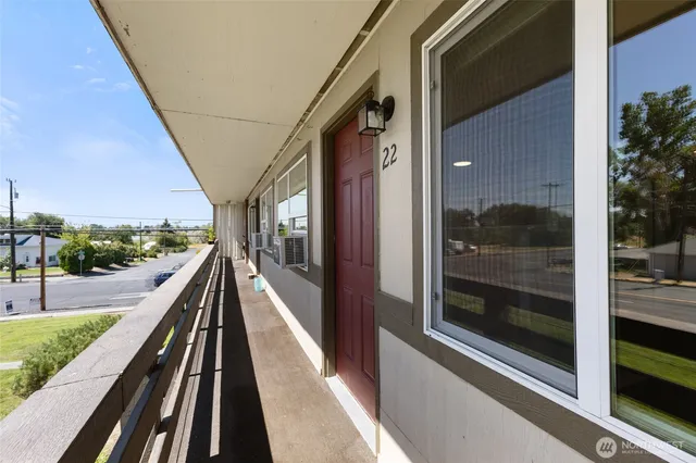a view of balcony with floor to ceiling windows and wooden floor