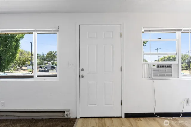 a view of a livingroom with wooden floor and a window