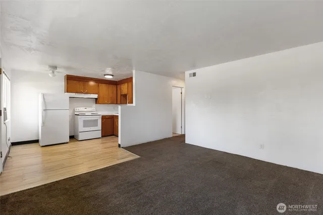 a view of a kitchen with a refrigerator a stove top oven