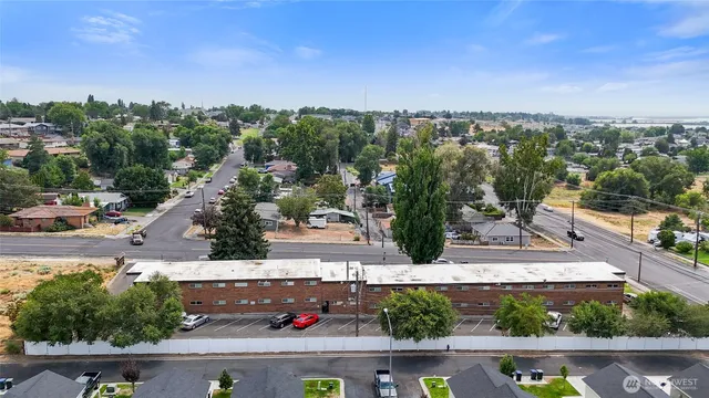an aerial view of a residential houses with outdoor space and street view