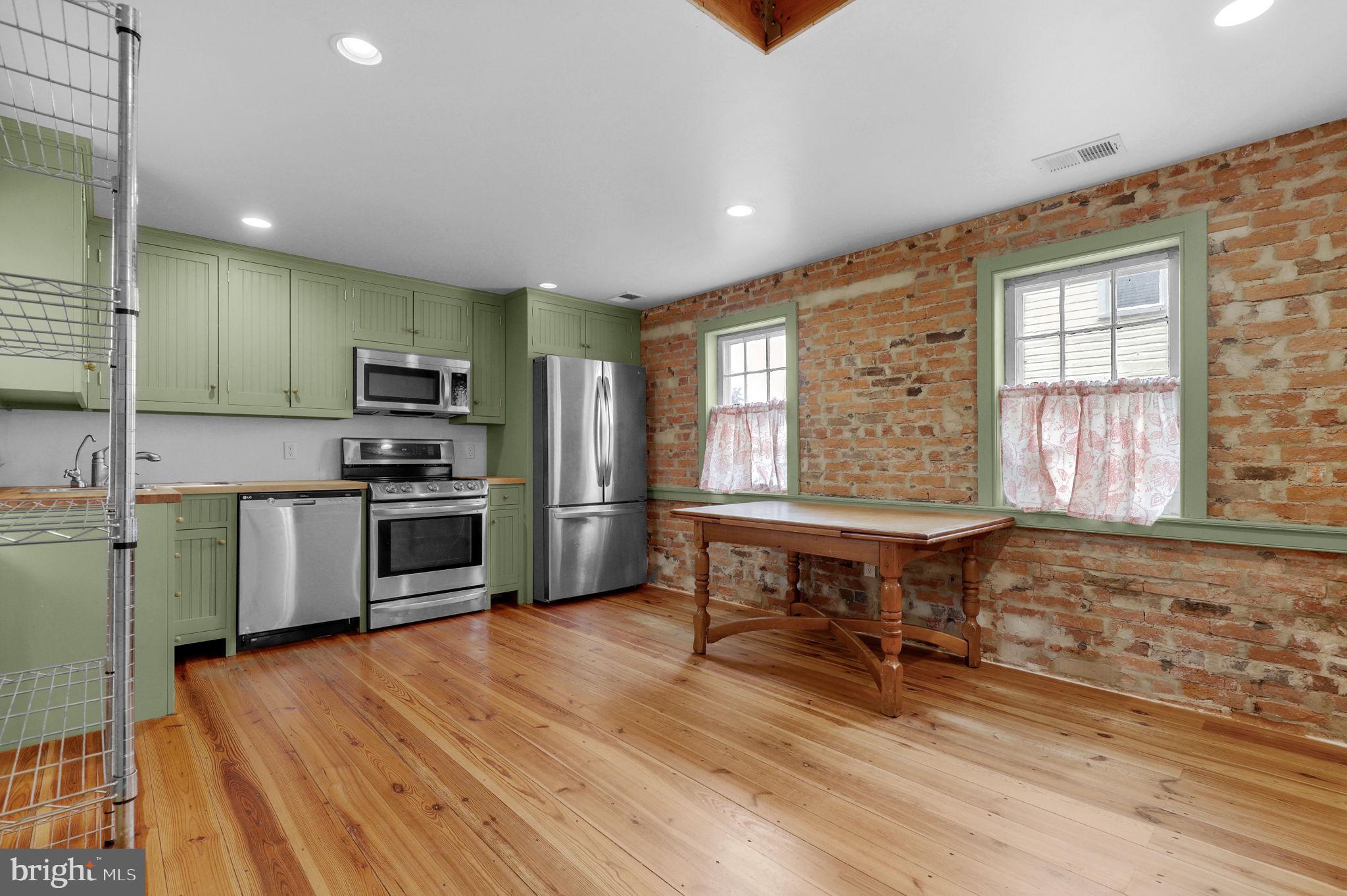 28 Potomac Street Boonsboro, MD 21713 - Photo 13 of 52 a kitchen with stainless steel appliances kitchen island granite countertop a stove a sink and a refrigerator