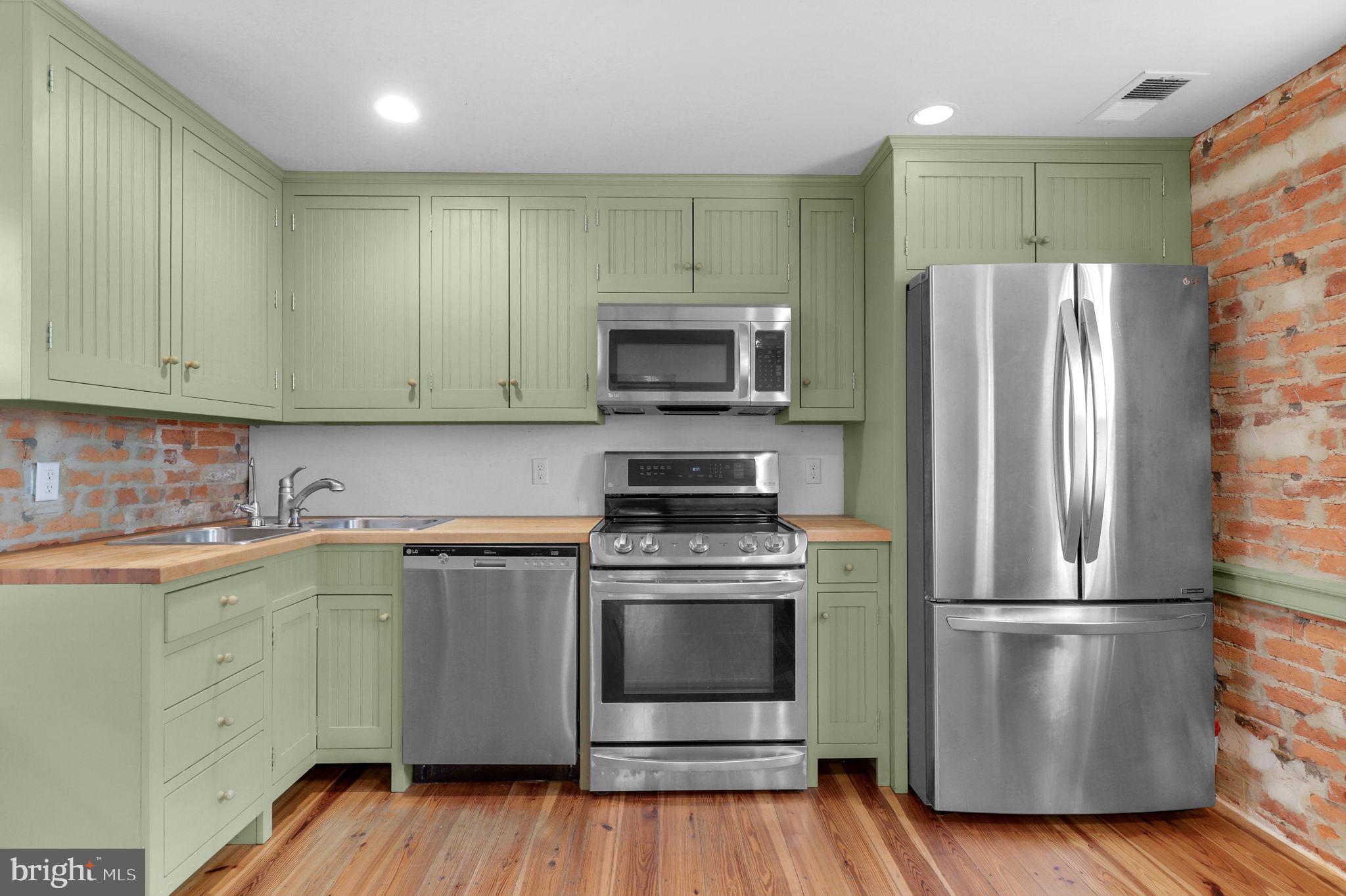 28 Potomac Street Boonsboro, MD 21713 - Photo 14 of 52 a kitchen with a stove top oven and refrigerator