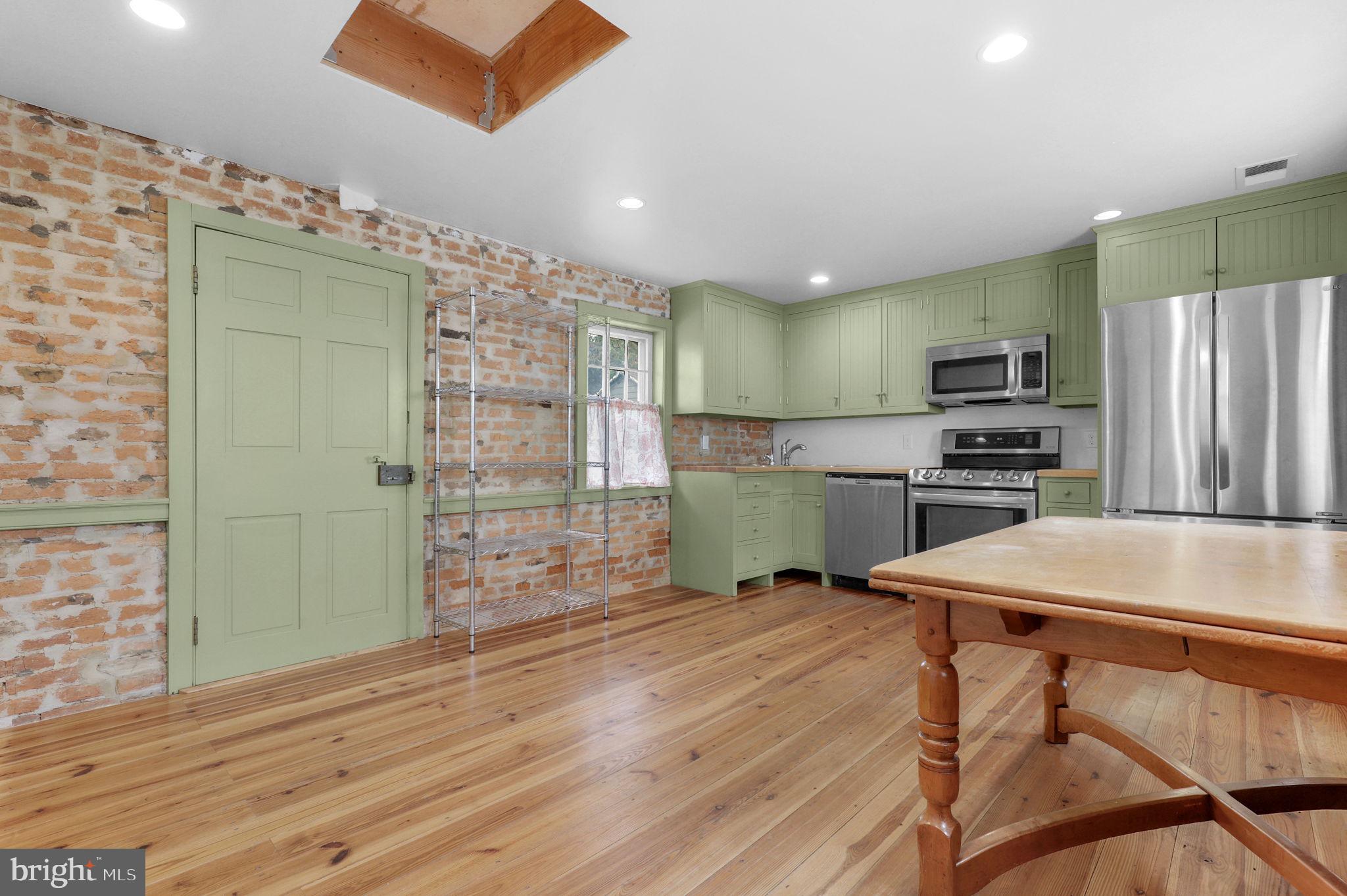 28 Potomac Street Boonsboro, MD 21713 - Photo 16 of 52 a kitchen with kitchen island a counter top space cabinets and stainless steel appliances