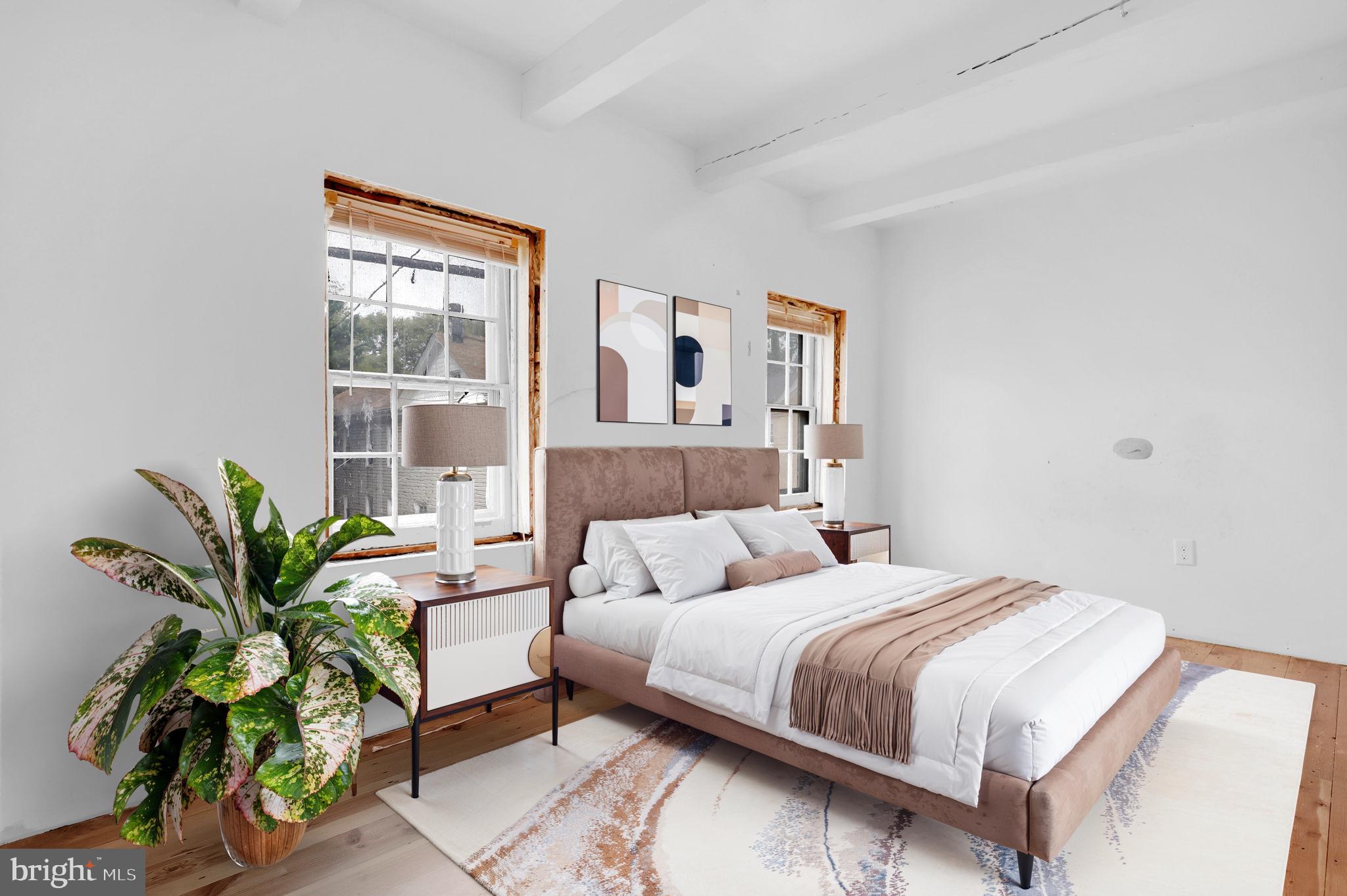 28 Potomac Street Boonsboro, MD 21713 - Photo 21 of 52 a bedroom with a bed and a potted plant