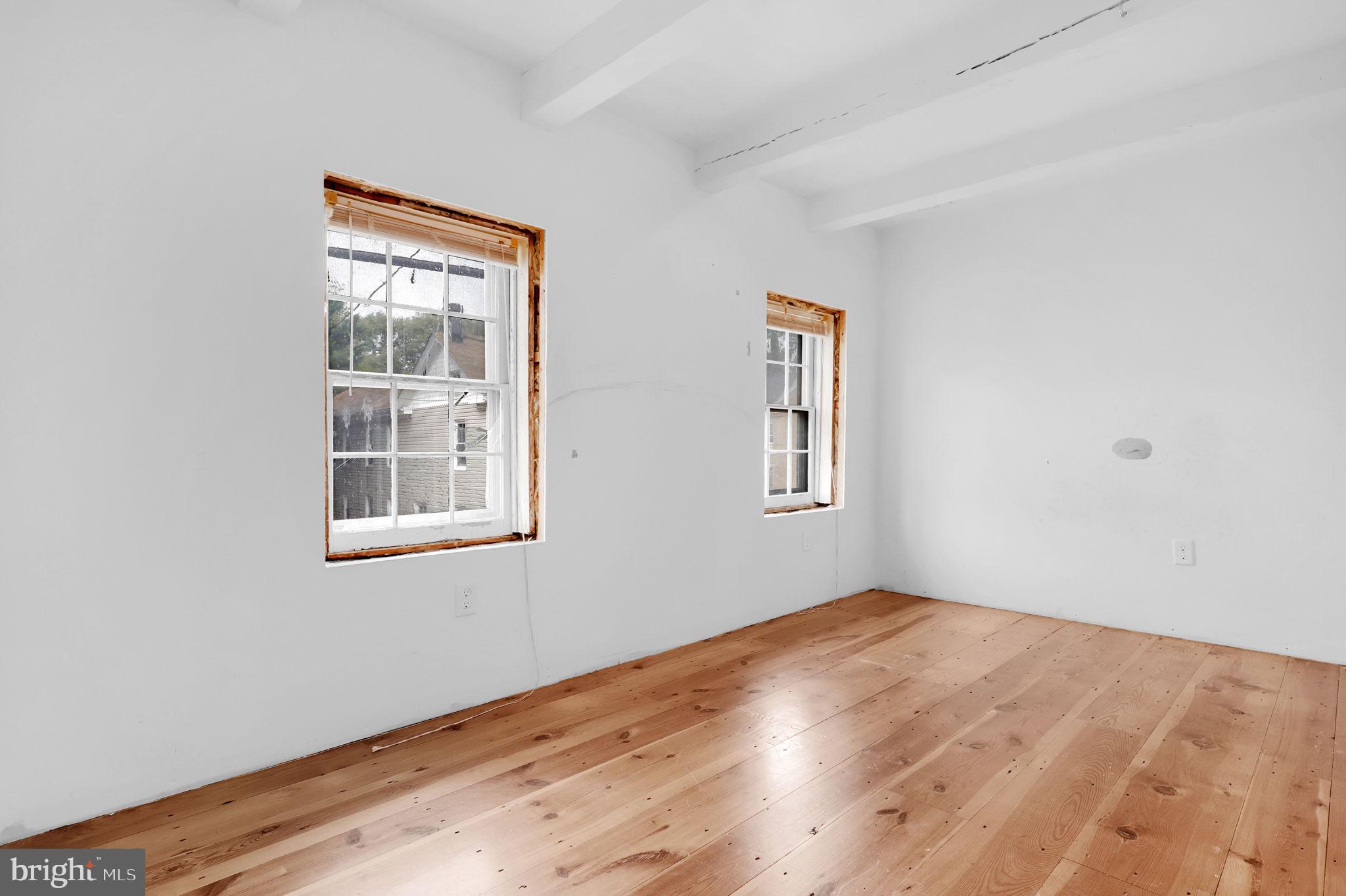 28 Potomac Street Boonsboro, MD 21713 - Photo 22 of 52 an empty room with wooden floor and windows